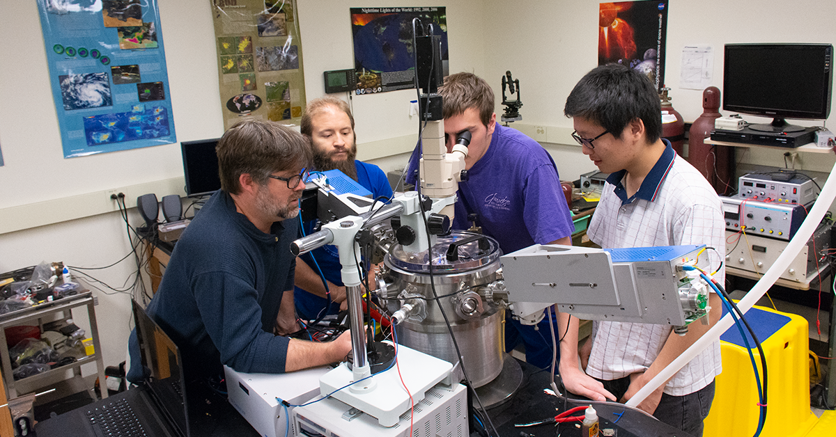 Dr. Nathan Magee (left) with students